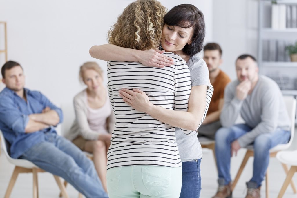 people hugging in the support group