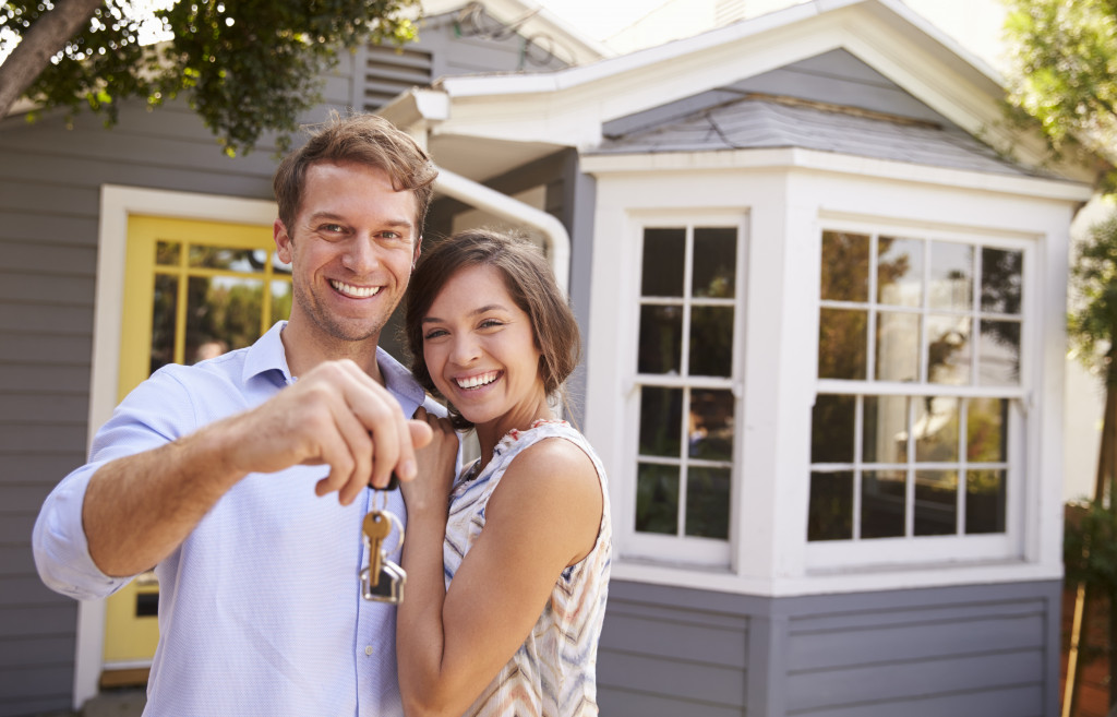 man and woman owning a home