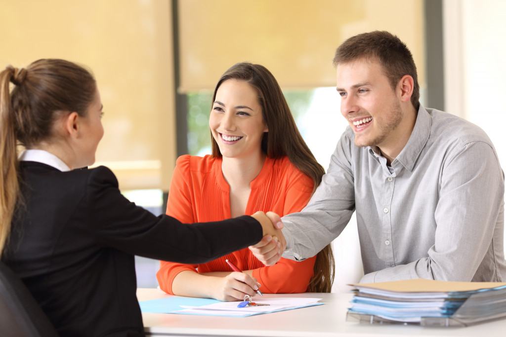 person shaking hands with clients