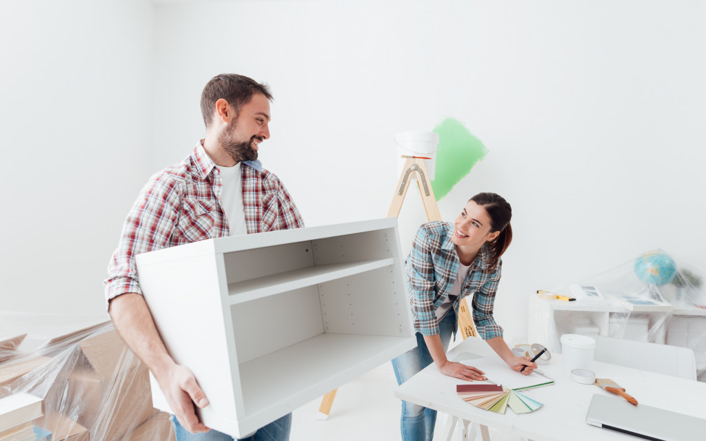 man and wife remodeling a house