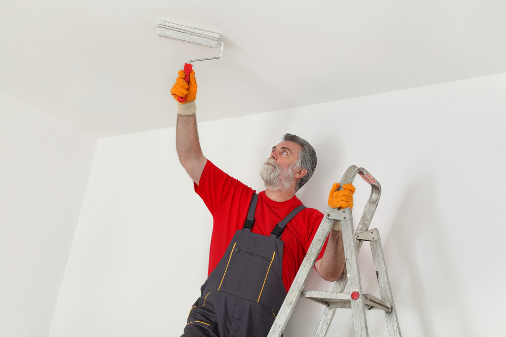 man painting ceiling