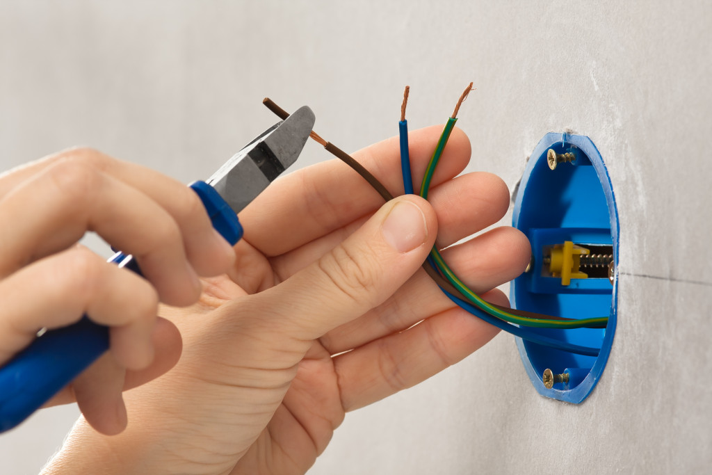 hand repairing the electrical wirings