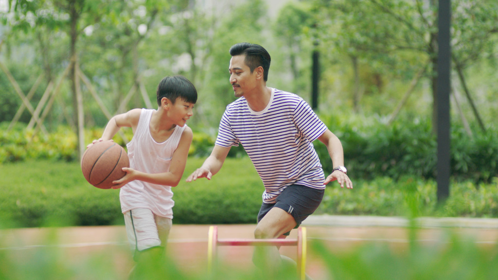 father and son playing basketball