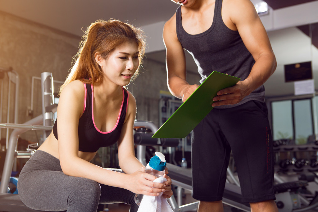 A woman and man talking in the gym