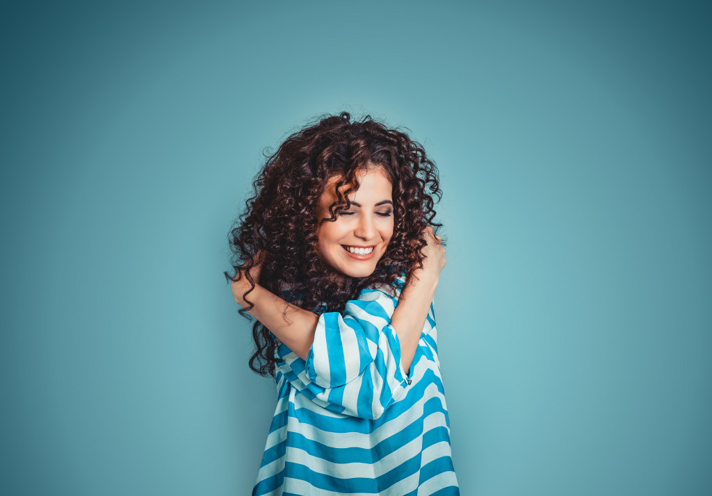 a woman hugging herself