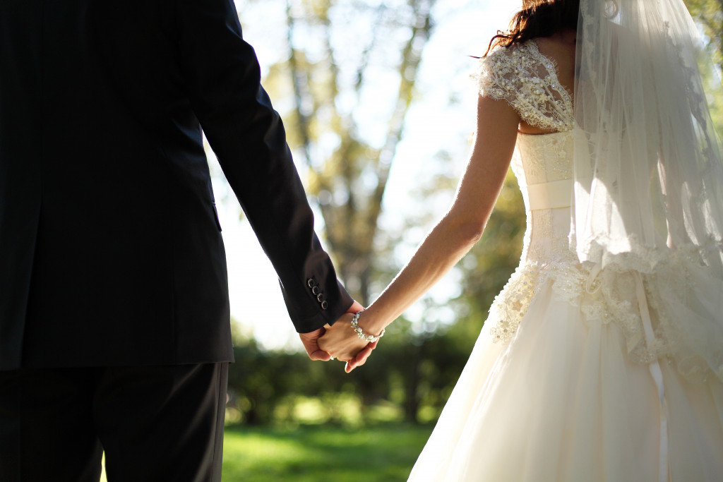 newly wed couple holding hands