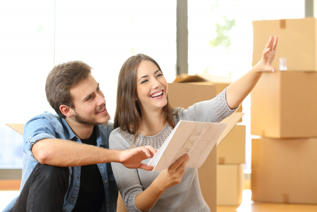 a man and woman smiles as they plan about the future