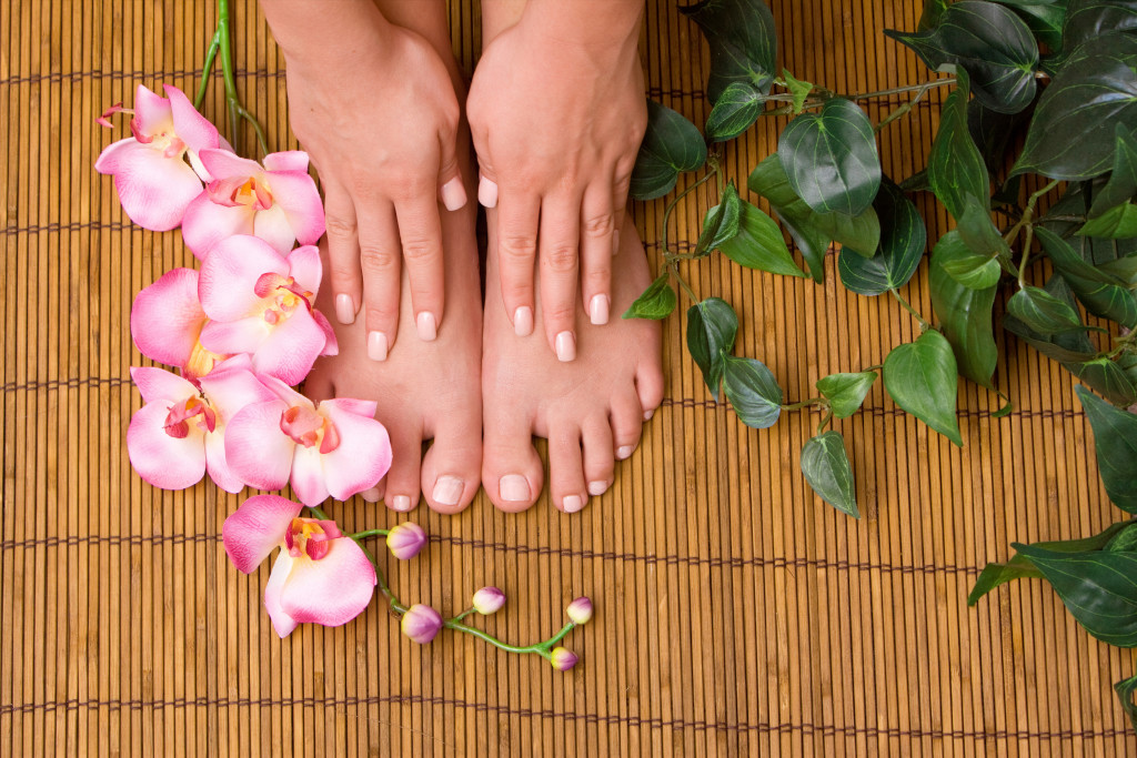 Beautiful hand and feet of a women indicating manicure and pedicure concept