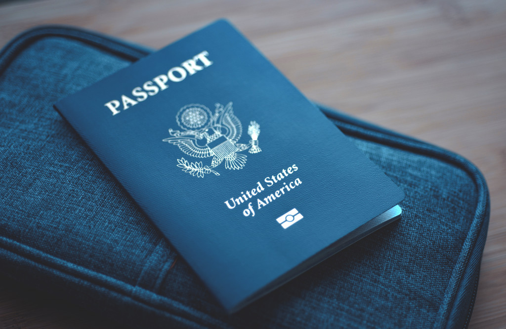 US passport on top of a blue wallet.