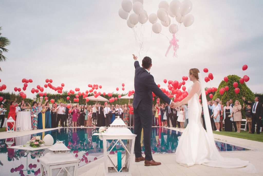 couple releasing white balloons on their wedding day