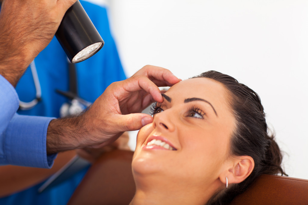 doctor checking eye health of patient