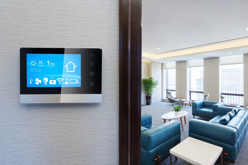 smart thermostat installed in a wall overlooking a blue-themed living space