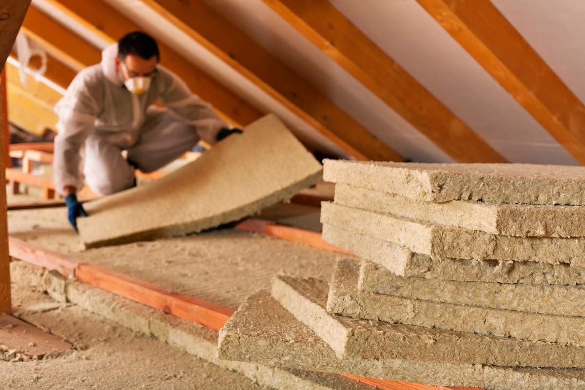 man installing thermal insulation