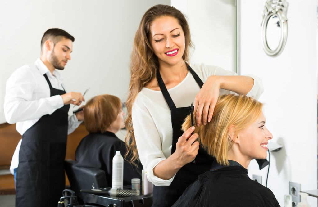 Women getting haircuts in a salon