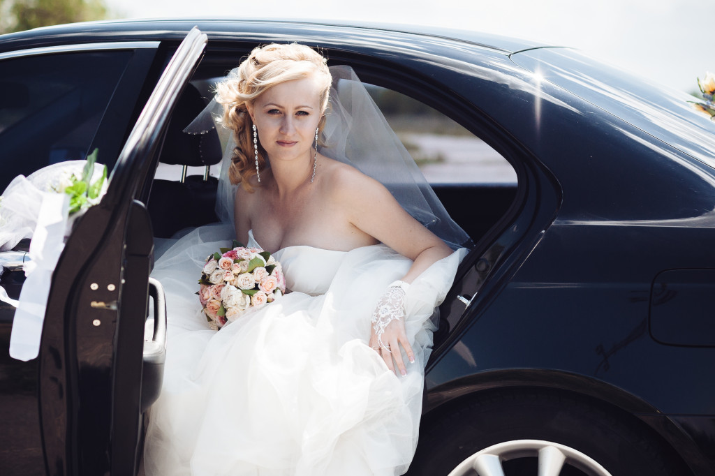 bride about to go out from the car